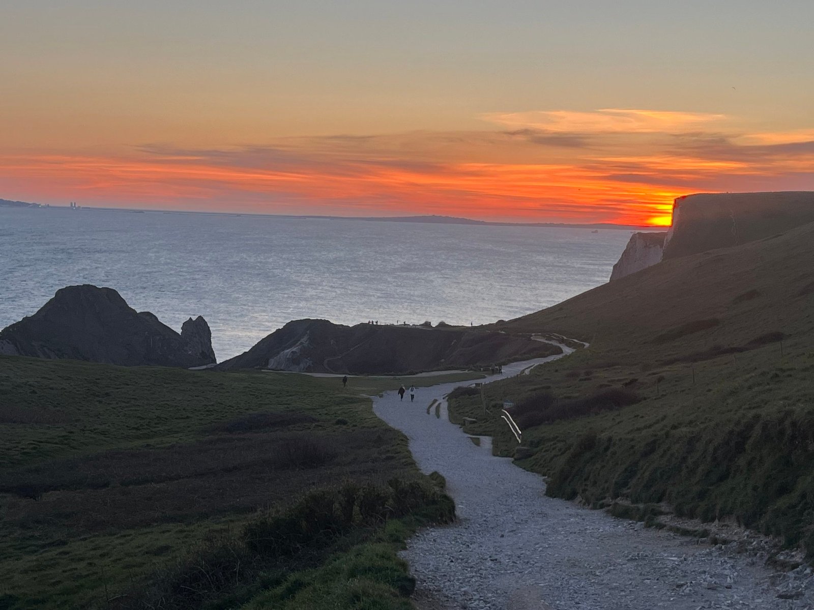 Sunset over the sea from the footpath to Durdle Door